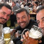 3 men with drinks smiling