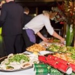 A Christmas buffet with crackers on the table