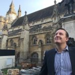 Image or person standing in front of an Oliver Cromwell statue