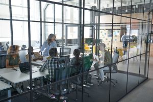 Employees making brainstorm for creating projects for new clients. Meeting of staff. Interior of office