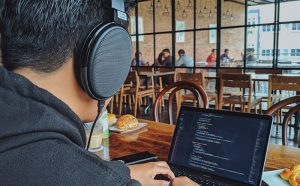 Man on laptop in eatery